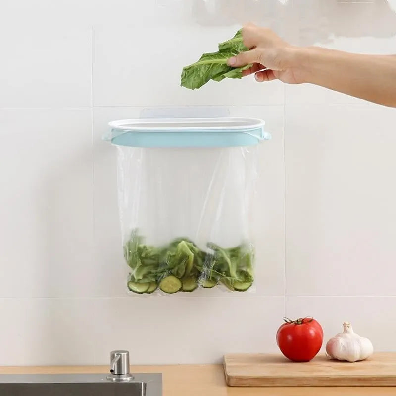 Blue foldable plastic kitchen garbage bag storage rack mounted on a cabinet door.