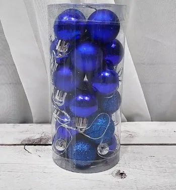 Shiny matte gold, red, silver, and blue 3 cm Christmas baubles spilling from a cardboard box.