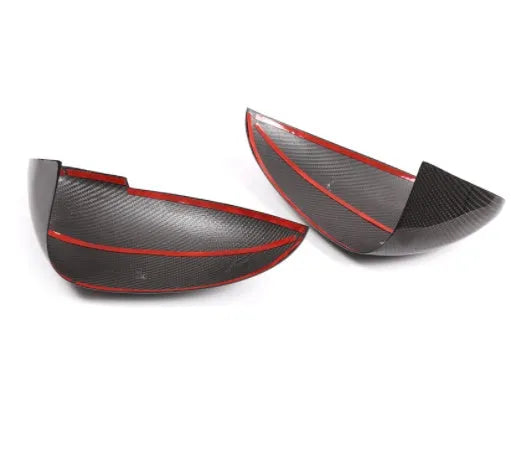 Black true carbon fibre rearview mirror cover for Porsche Macan on a white background