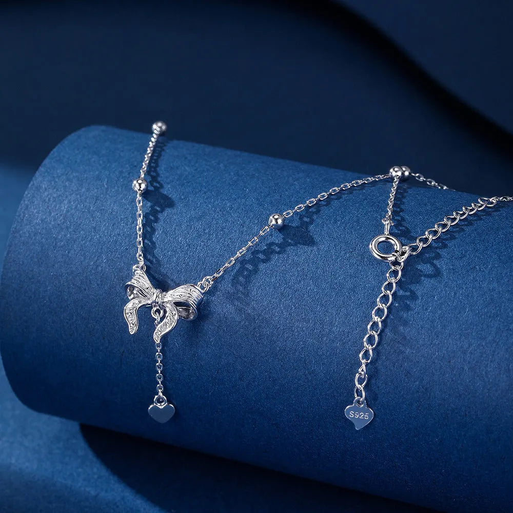 Women's 925 silver butterfly heart and bow pendant necklace on an adjustable O-ring chain.