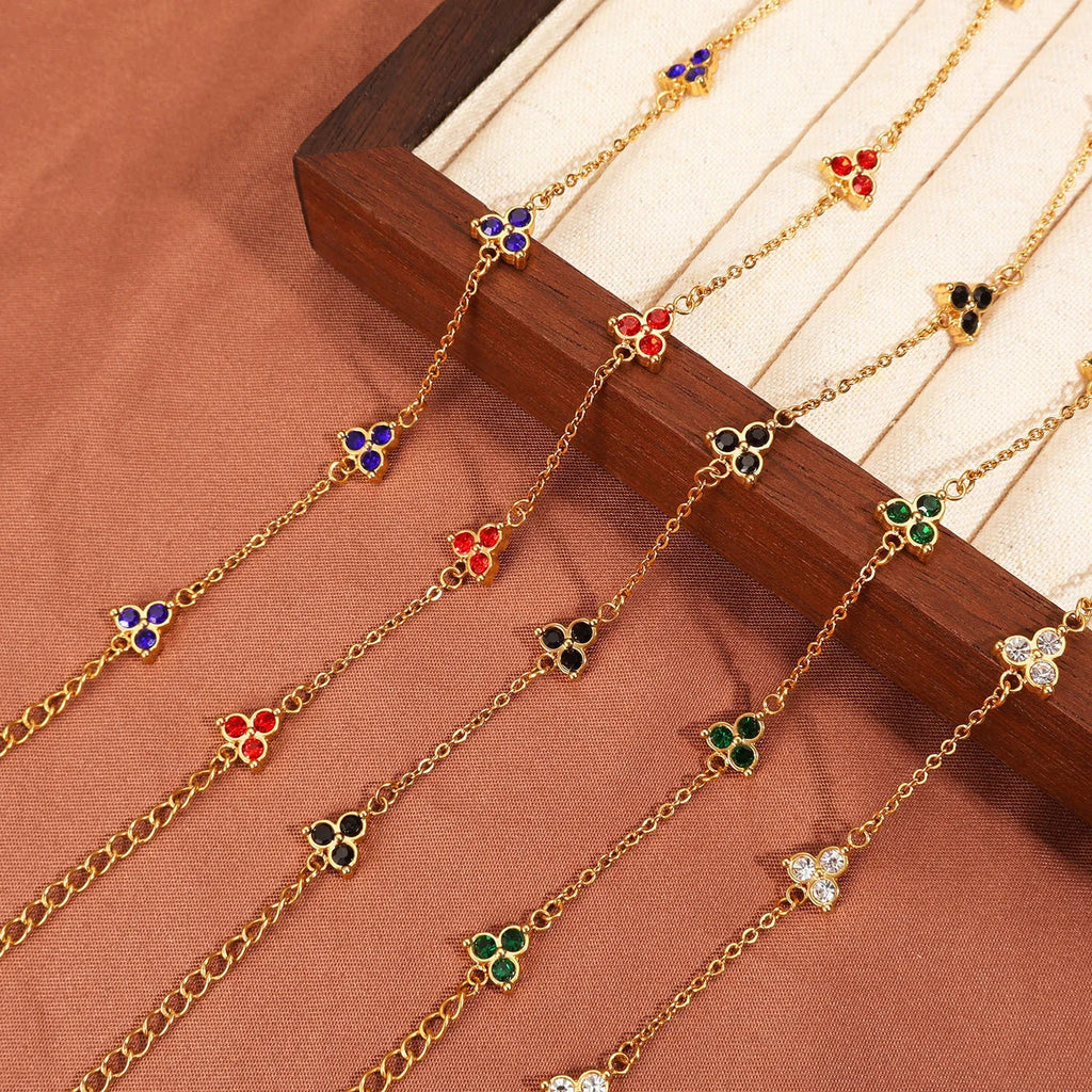 Women's stainless steel bracelet with a geometric triangle pendant, shown in gold and steel tone options with coloured stones.