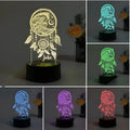 Black-based acrylic table lamp with colourful LED light effects on a desk, showing remote control.