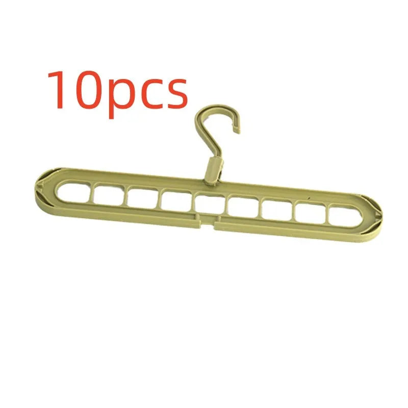 Green plastic nine-hole folding pant hanger for trousers and skirts.