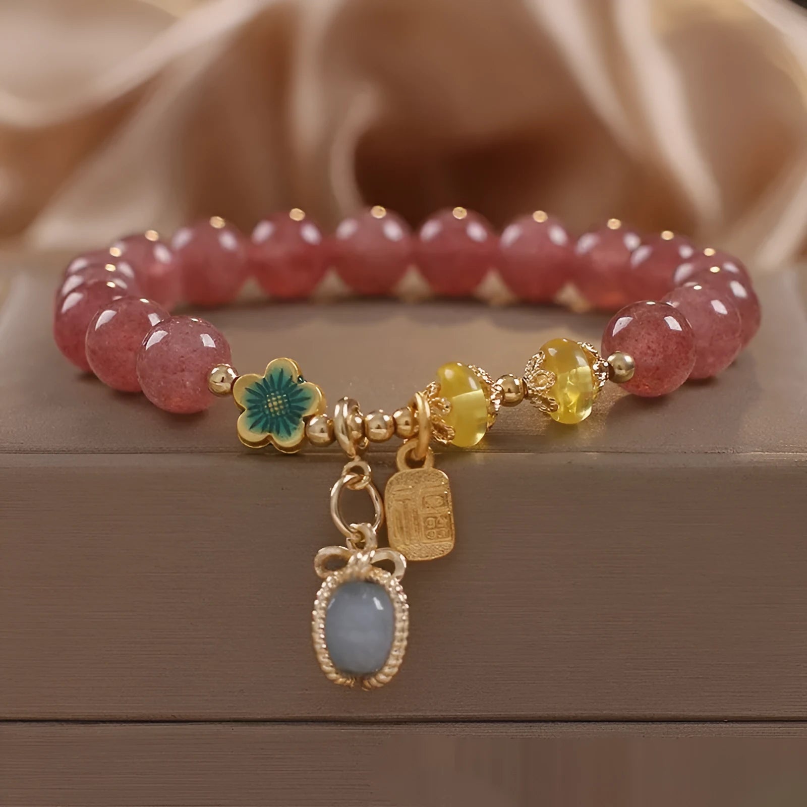 Red women's beaded bracelet with natural strawberry quartz stones and sparkling rhinestone accents.