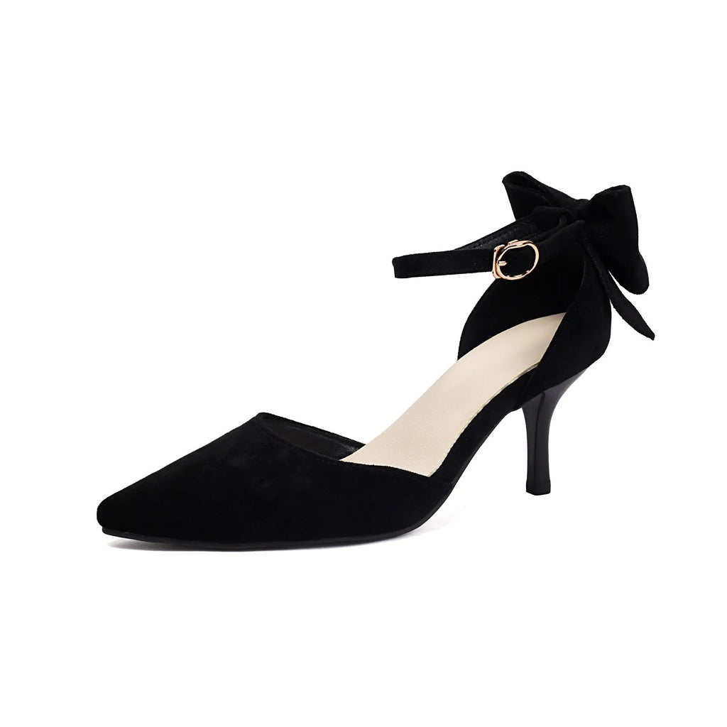 Women's black suede pointed-toe high heels with a stiletto heel and decorative bowknot at the ankle