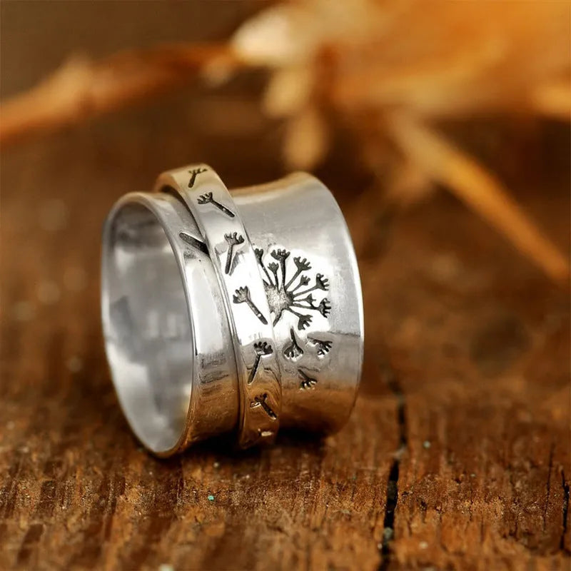 Silver rotatable flower fashion ring showing adjustable floral element and band