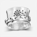Silver rotatable flower fashion ring showing adjustable floral element and band