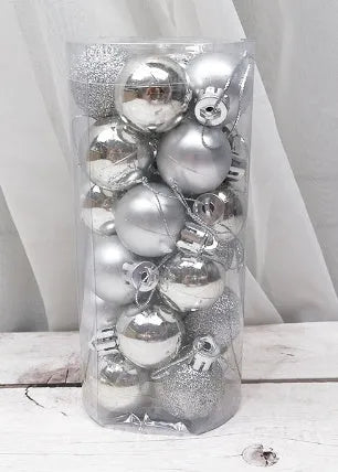 Shiny matte gold, red, silver, and blue 3 cm Christmas baubles spilling from a cardboard box.
