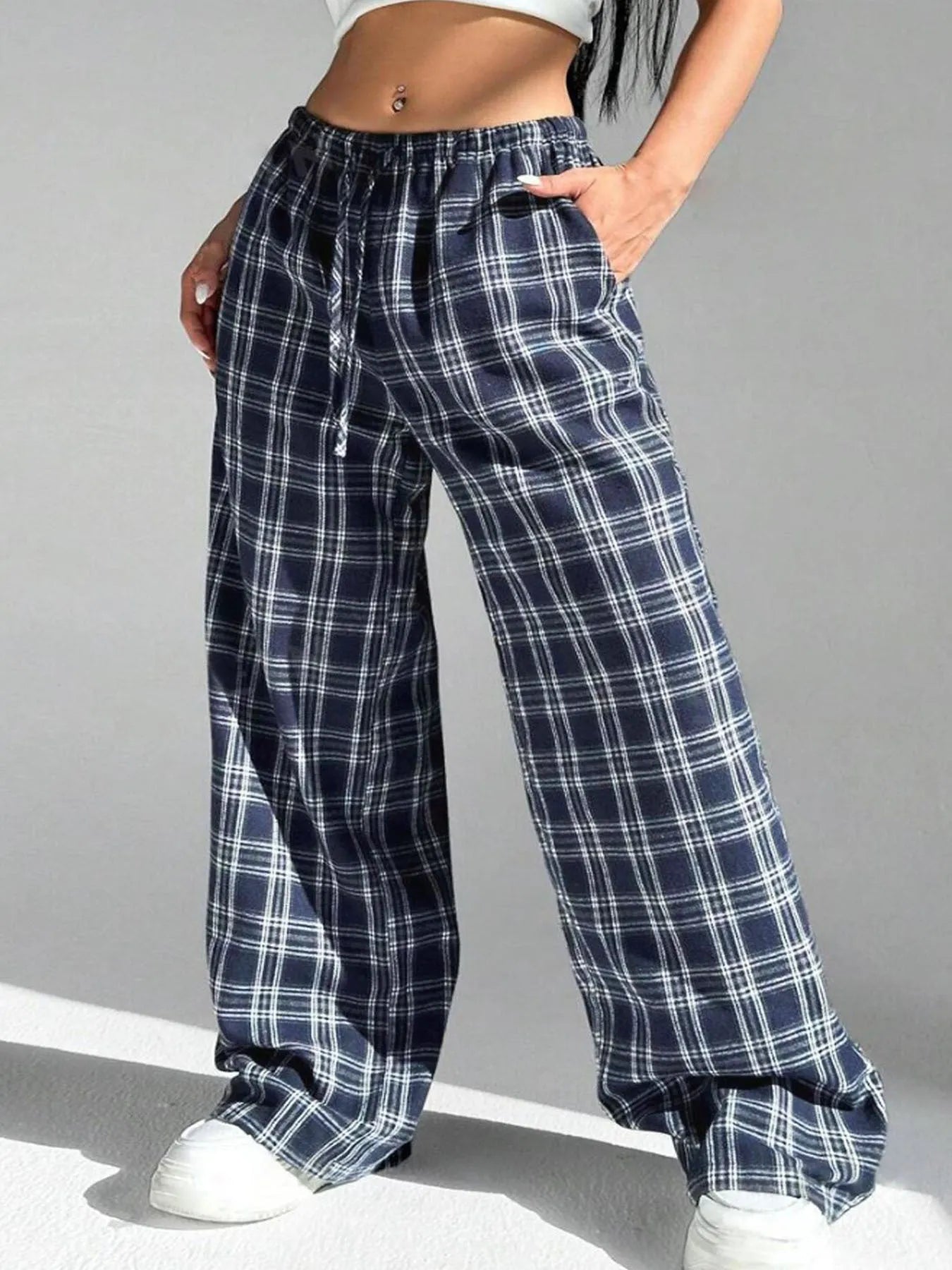 Women's red plaid loose trousers with drawstring waist and side pockets laid flat