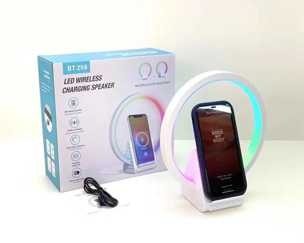 White smart Bluetooth speaker with wireless charging pad and ambient lighting measuring 225mm wide