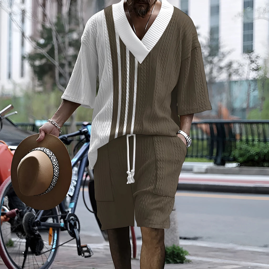 Man wearing a printed knitted drop-shoulder short-sleeved top with matching shorts from a co-ord suit set.