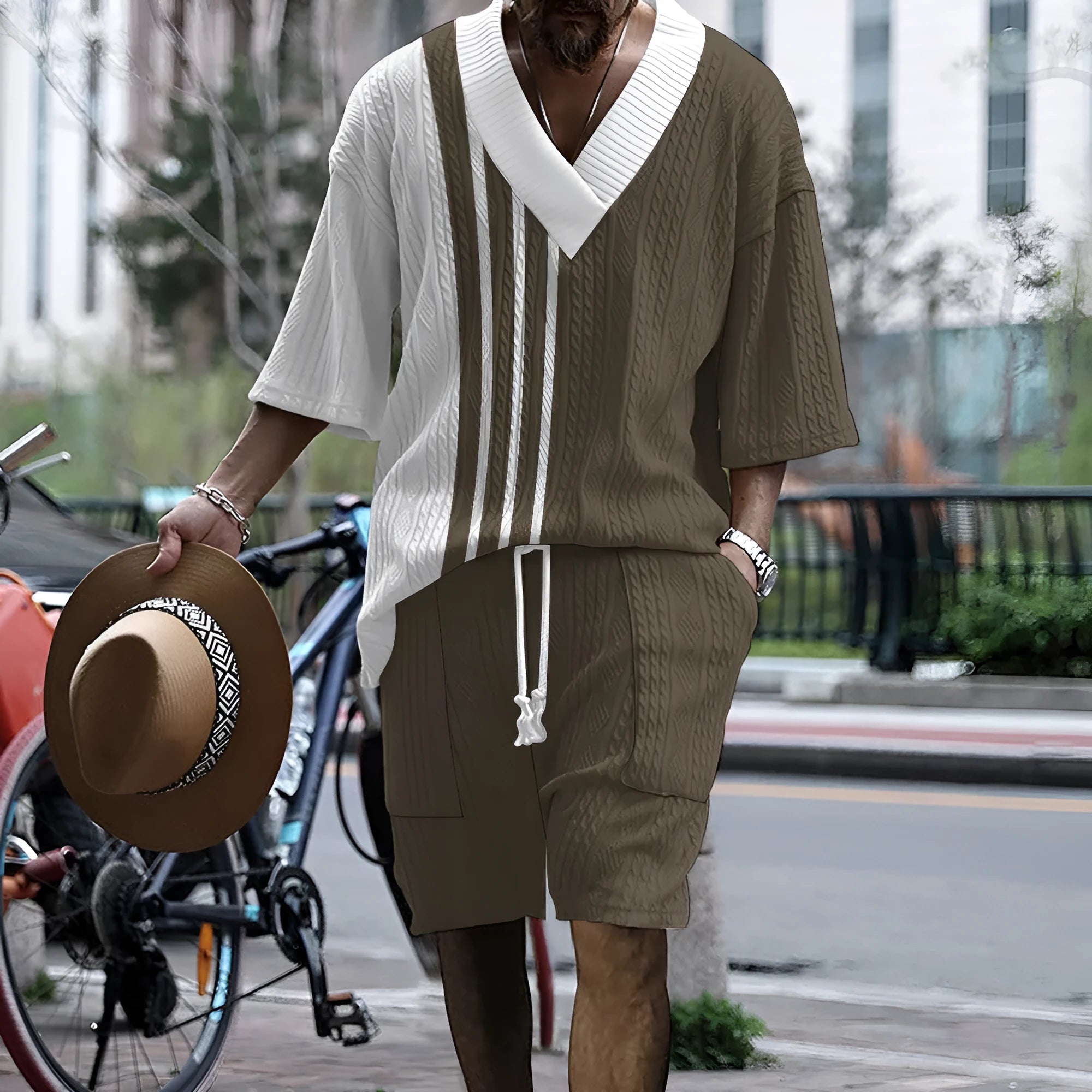 Man wearing a printed knitted drop-shoulder short-sleeved top with matching shorts from a co-ord suit set.