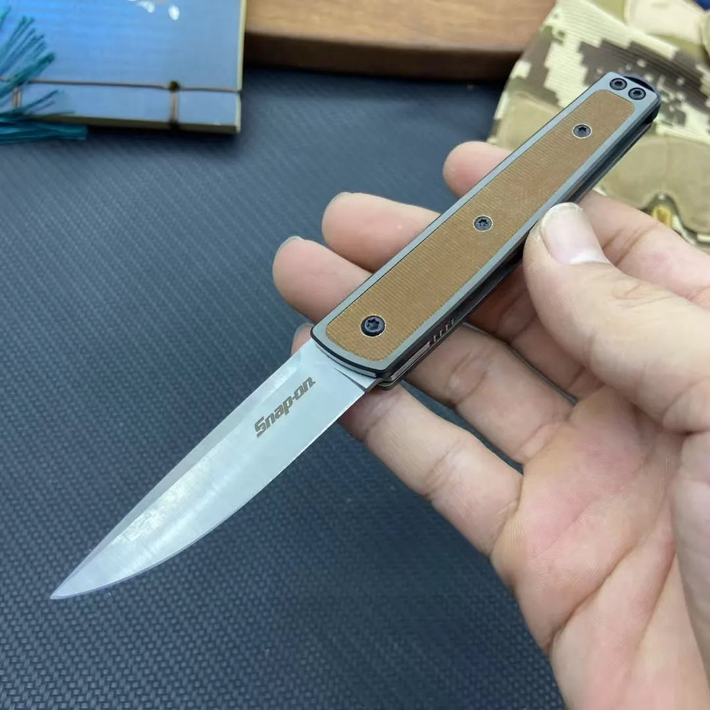 Folding fruit knife with stainless steel blade shown in black, brown, and red colour options