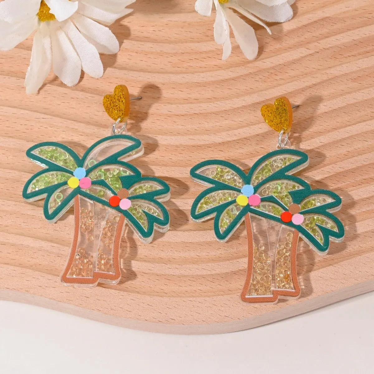 Colourful acrylic novelty earrings shaped like fruits and desserts including cherry, strawberry, and ice cream.