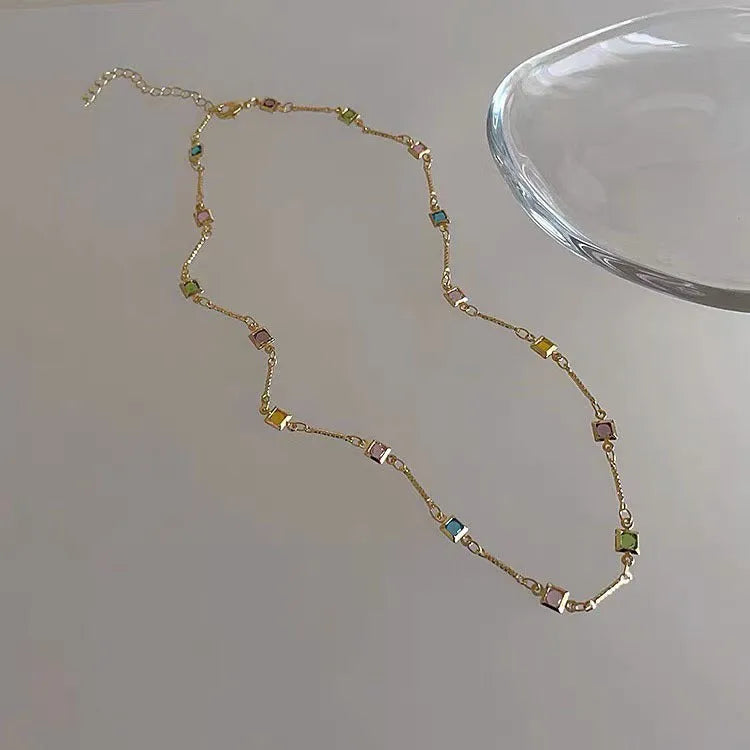 Square colour clavicle chain necklace with geometric quadrilateral crystal elements in gold and white K finishes