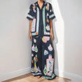 Women's black casual set with cartoon print, featuring a long-sleeve cardigan and matching trousers