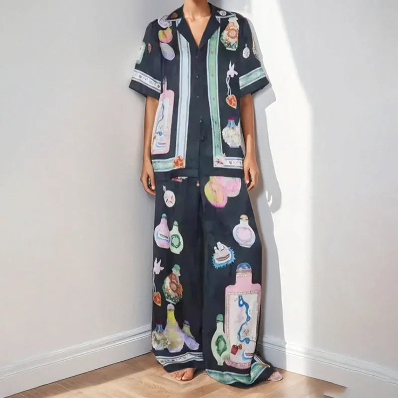 Women's black casual set with cartoon print, featuring a long-sleeve cardigan and matching trousers