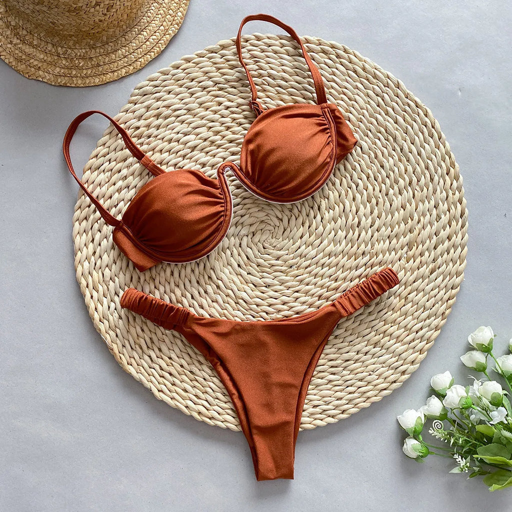 Women's black underwire bikini swimsuit on a mannequin, showing brief style and supportive fit.