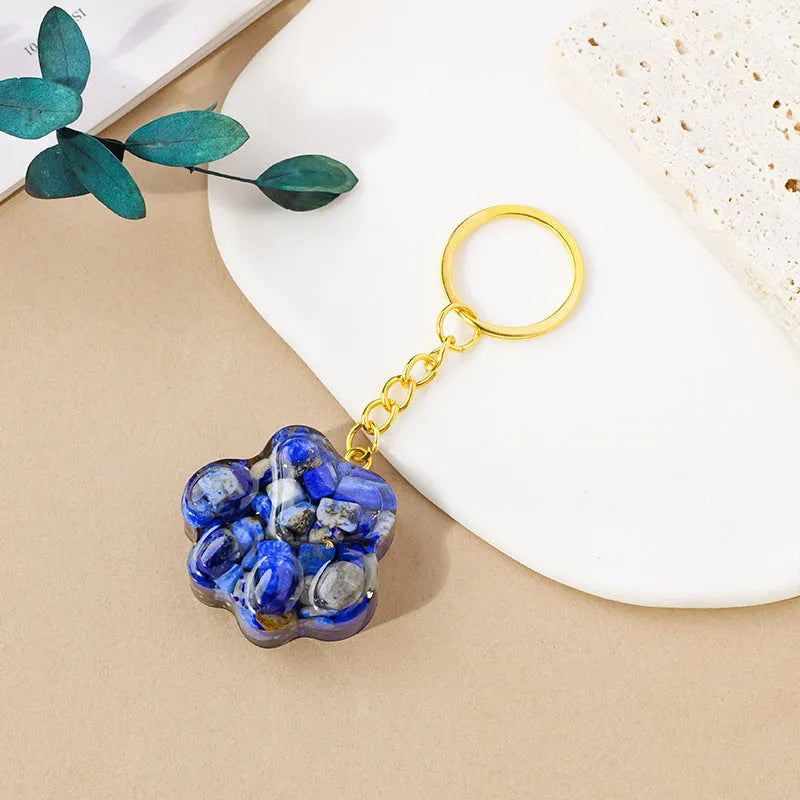 Small natural crystal cat's paw shaped pendant on a metal keyring, available in various crystal colours.
