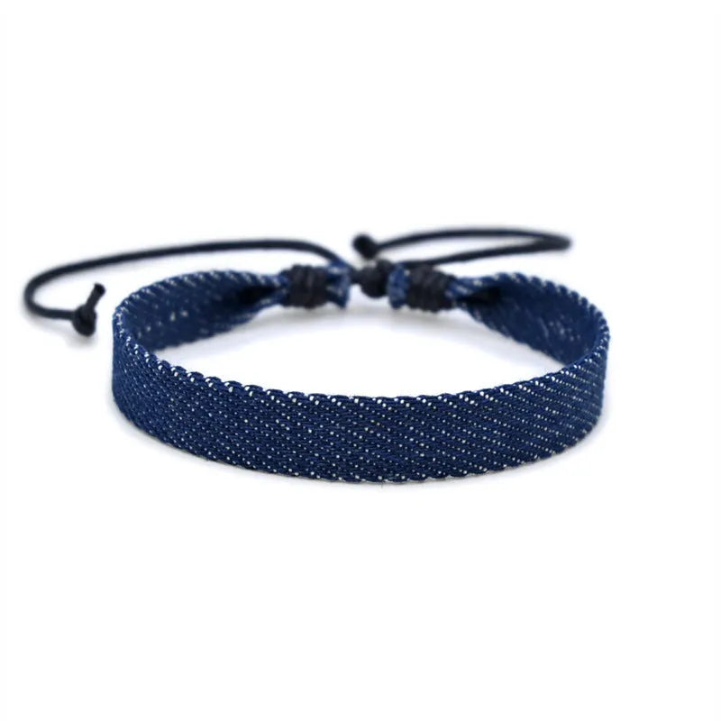 Handmade denim fabric wristband carrying strap in mixed materials with adjustable closure