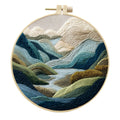 Embroidery DIY kit with printed landscape fabric, embroidery threads, needles, and frame for handmade cloth art
