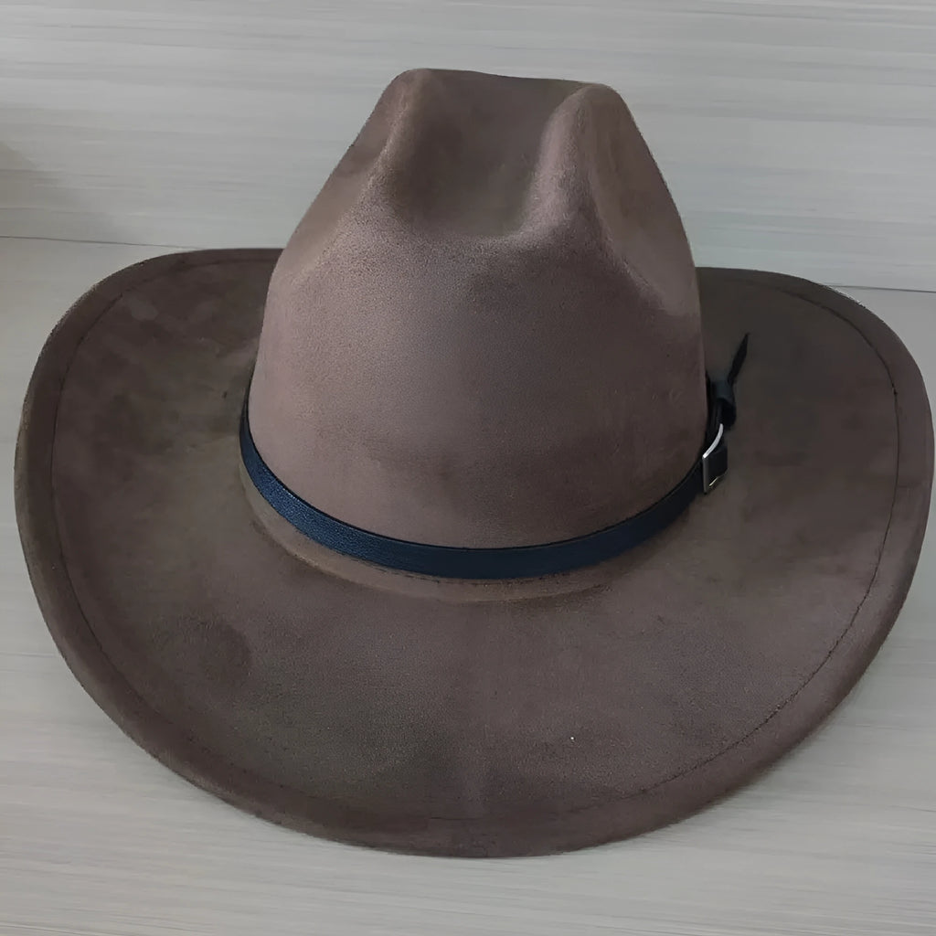 Brown leather velvet cowboy hat with a curved edge and conical crown on a plain background.