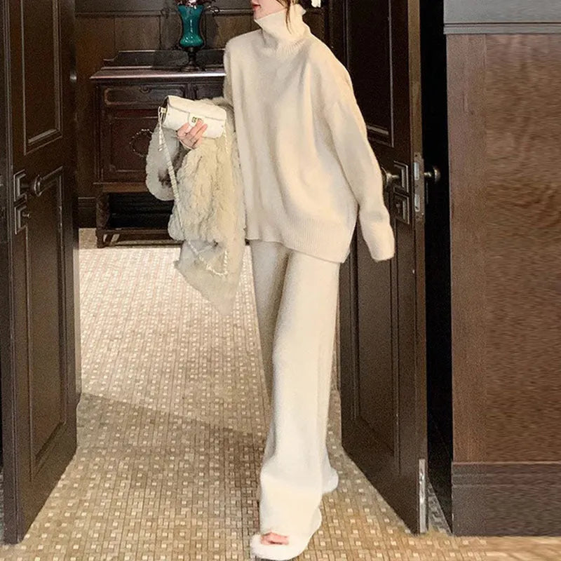 Women's beige acrylic sweater and wide-leg pants two-piece set laid flat.