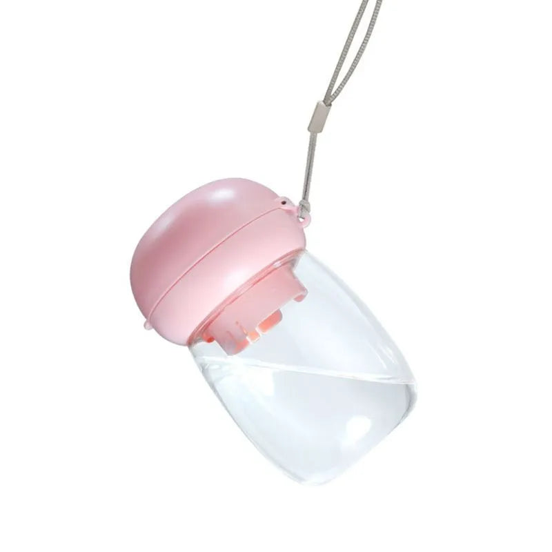 Portable dog water bottle with press-button cup in white on a green background