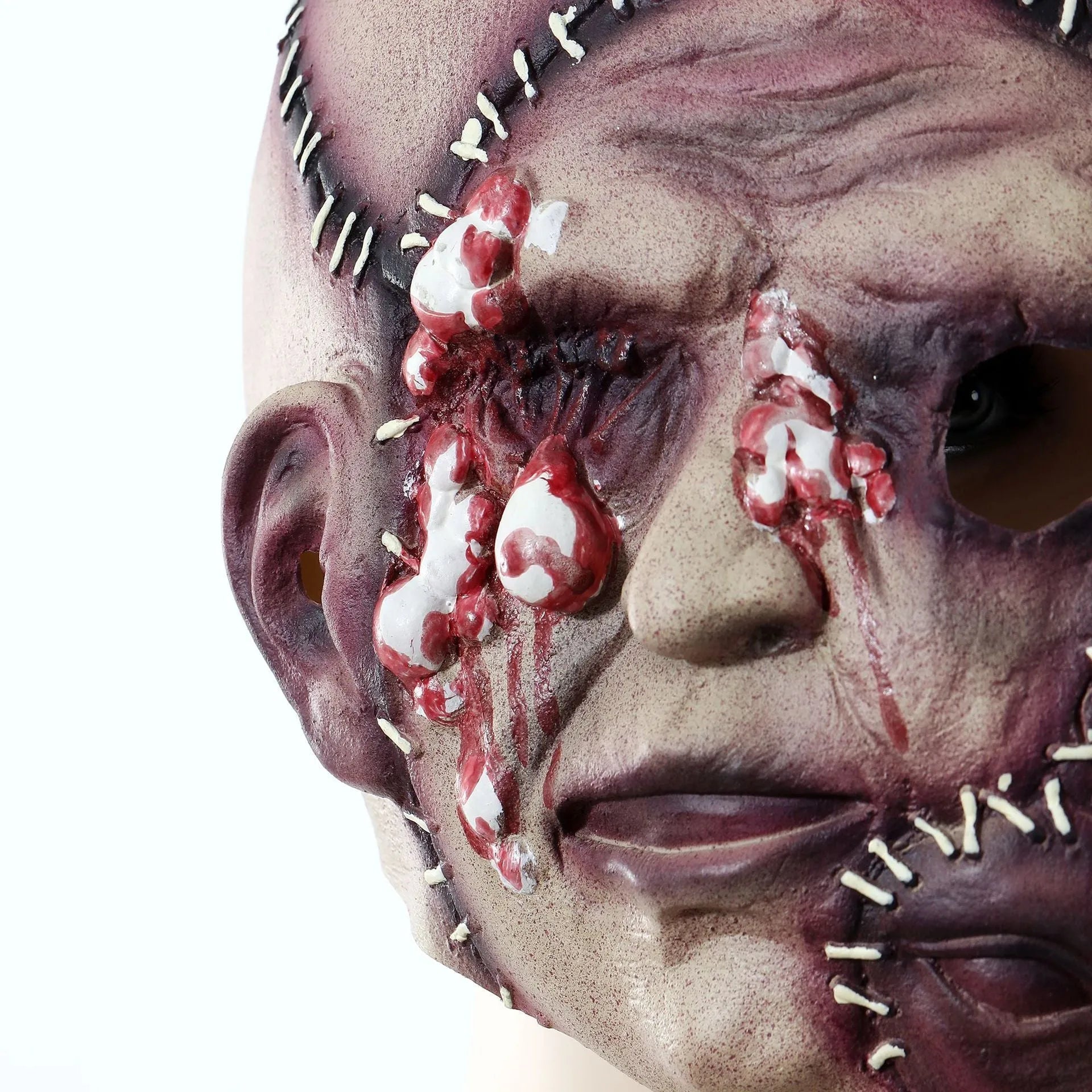 Three-sided grimace horror mask showing three distinct grotesque faces in natural latex