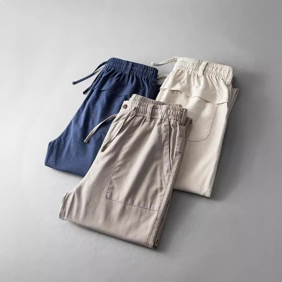 Men's mid waist linen trousers in solid colours showing trousers length and casual styling