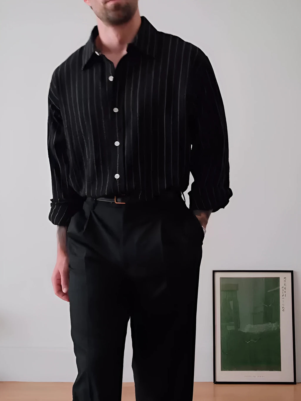 Black and white pinstriped long sleeve button-down shirt on a hanger.