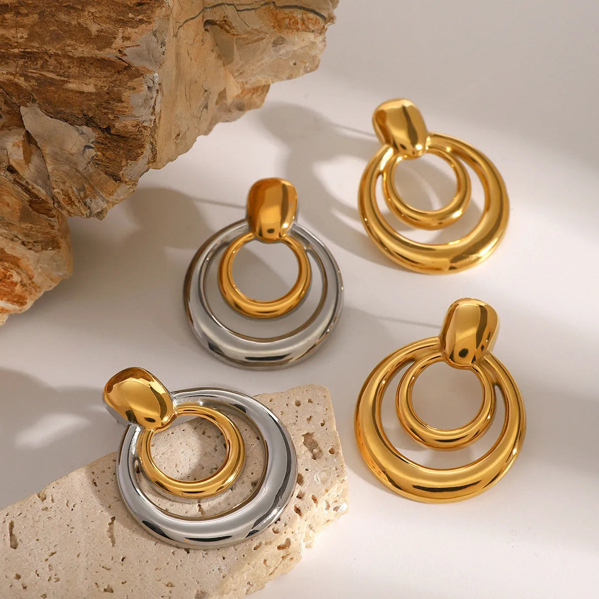 Golden round titanium steel hollow stud earrings with double layer construction and hypoallergenic properties