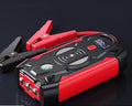 Red car emergency jump starter power pack with crocodile clips and digital display screen