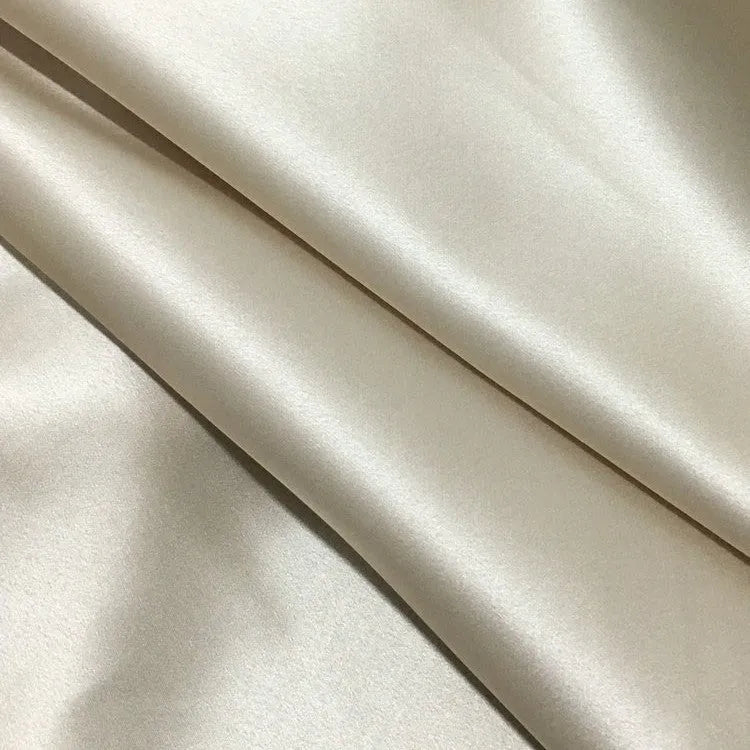 Dark grey silk pillowcase with envelope closure on a bed