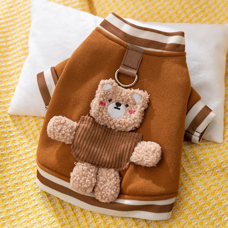 Soft navy blue dog sweater with light blue striped cuffs and blush bear decorations
