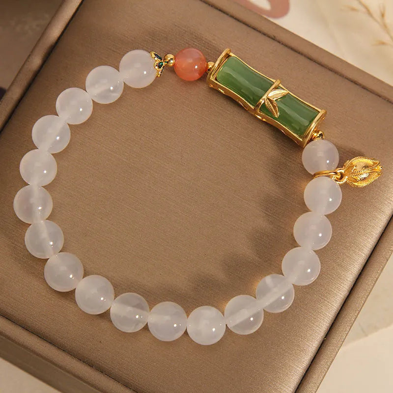 Women's natural style bracelet with jade beads, white agate centrepiece, and bamboo joint detailing.