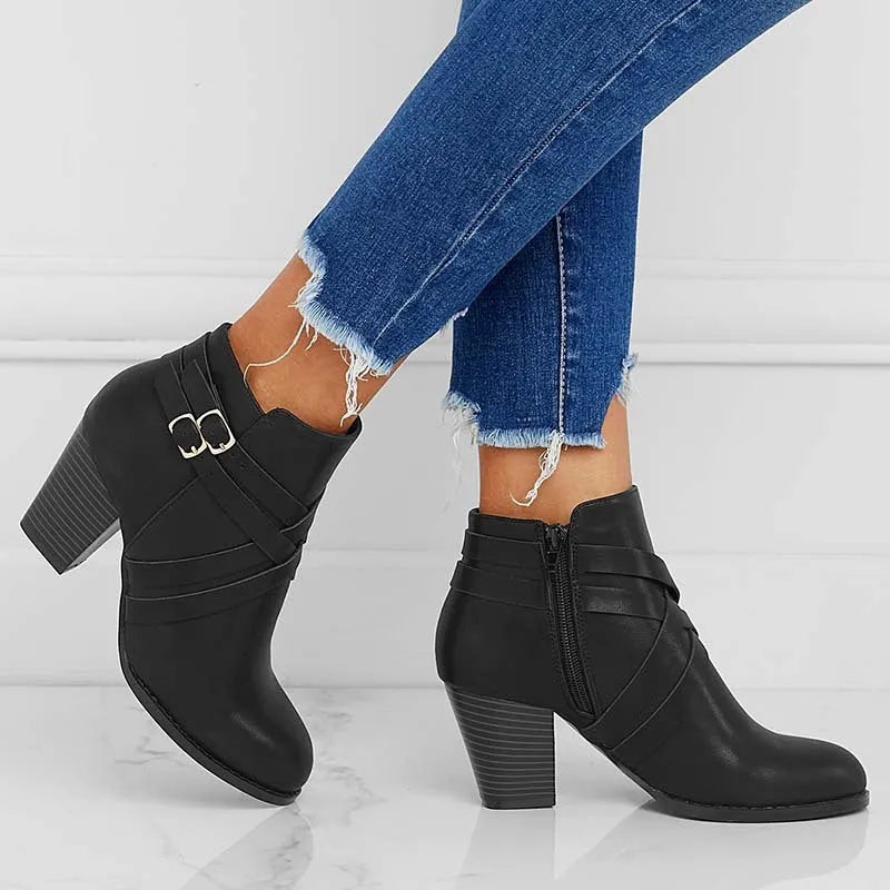 Women's black short boots with a 7cm stout heel and side zip fastener on a rubber sole.