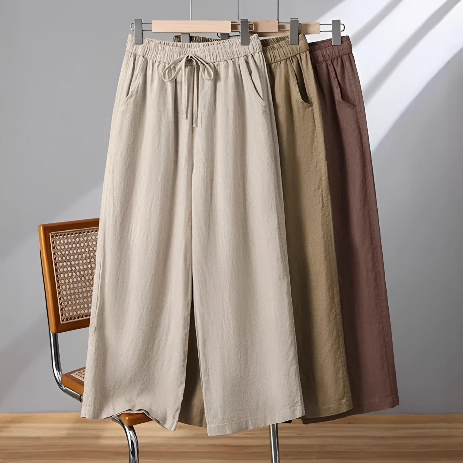 Women's apricot straight-leg casual trousers with an elastic lace-up waistband on a hanger.
