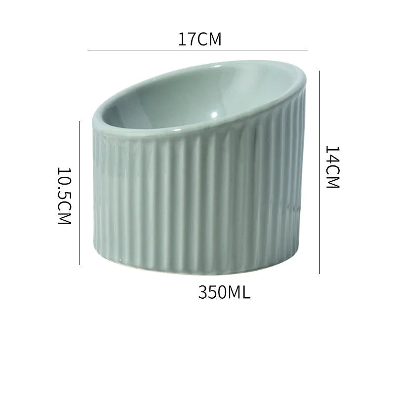 A dark green ceramic elevated cat bowl with a tilted, round shape.