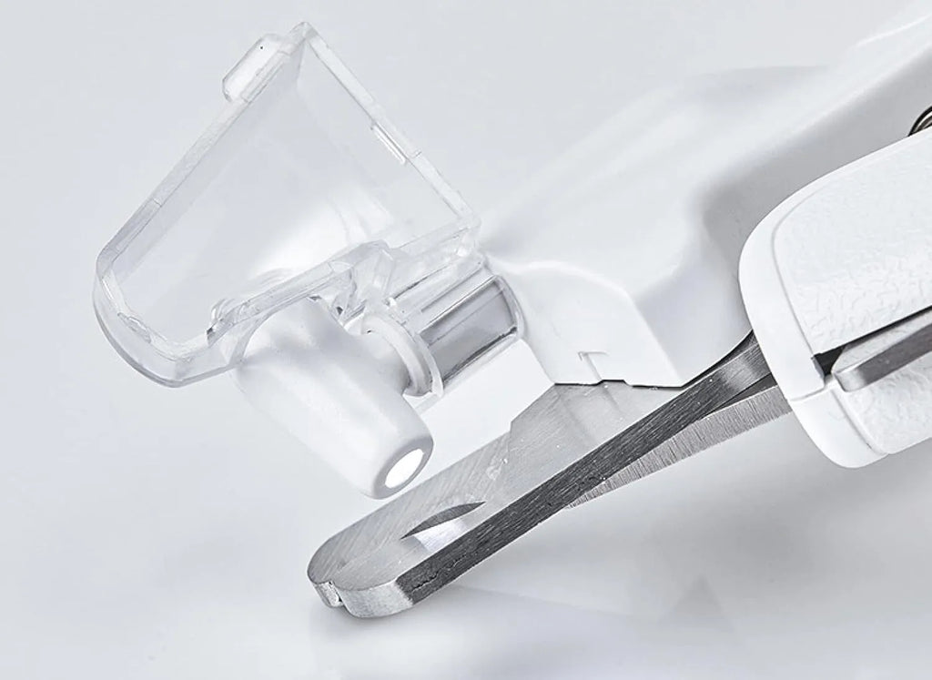 White pet nail clippers with LED light, transparent anti-splash baffle, and a nail file.