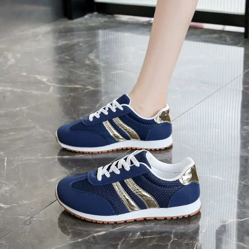 Blue women's tennis shoes with cross shoulder straps and lace-up front, artificial leather fabric uppers