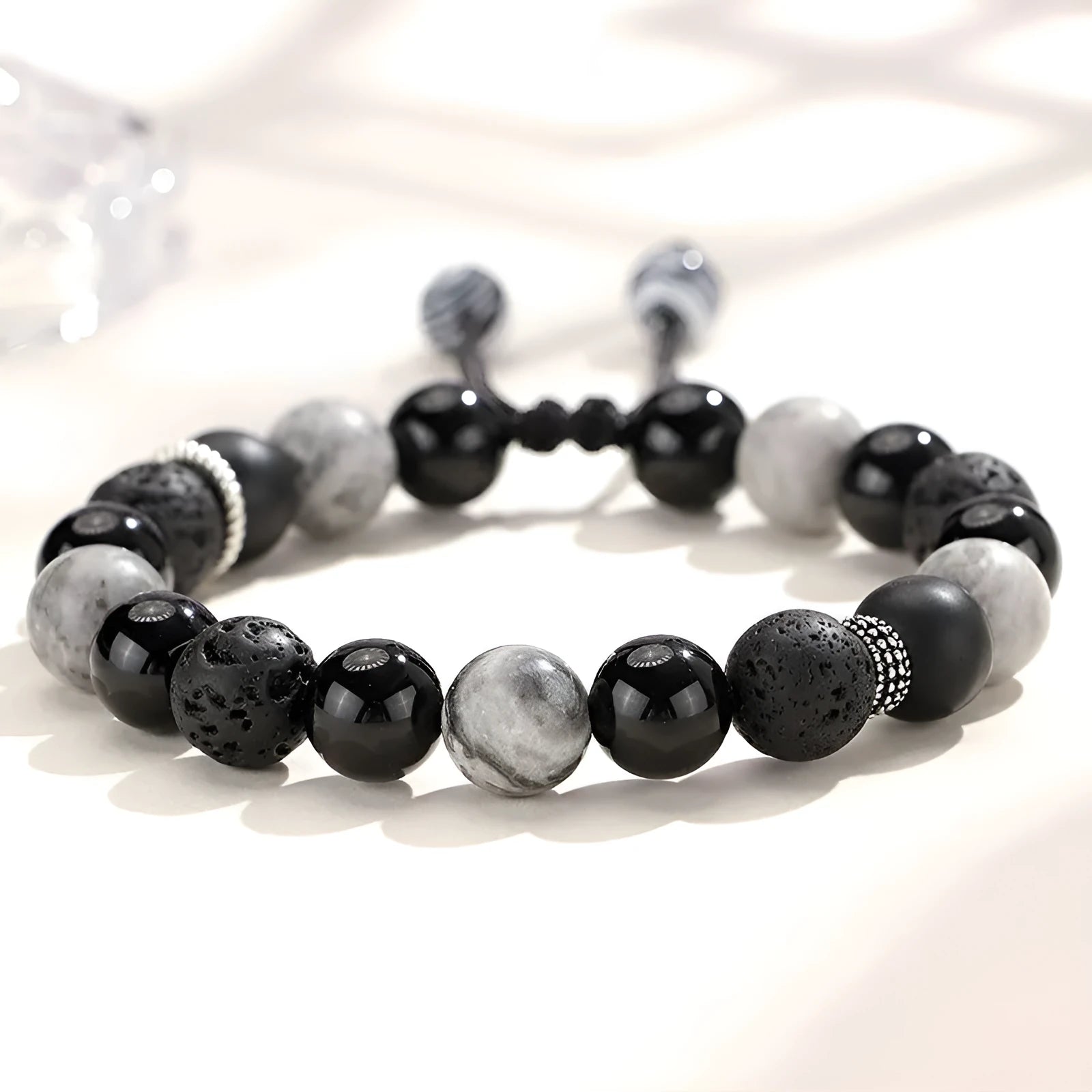 A black agate map stone volcanic rock bracelet with diamond-shaped beads in a New Chinese style unisex design.