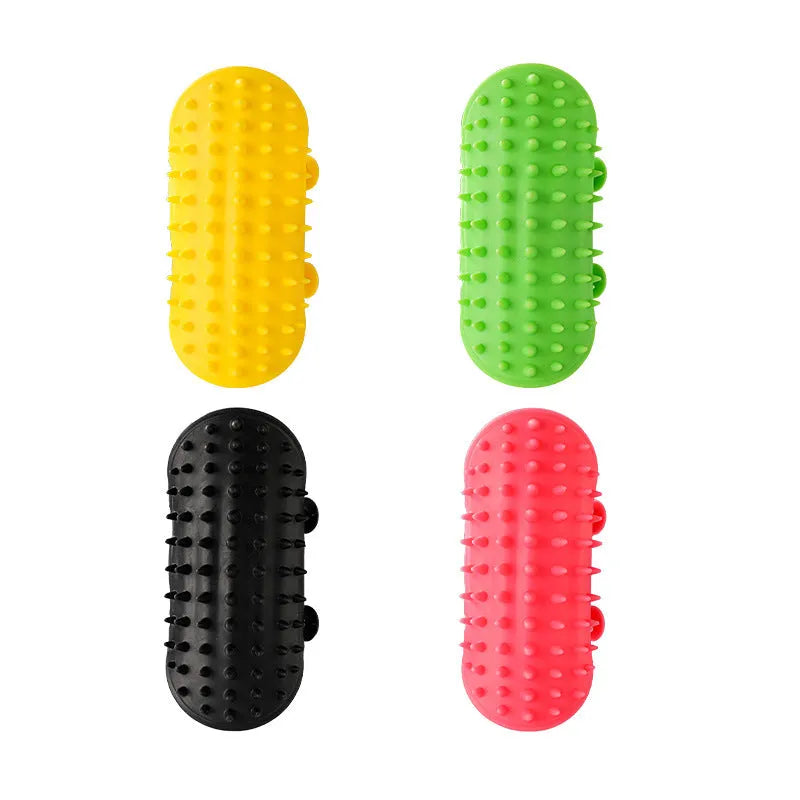 Silicone cat grooming comb with adjustable strap mounted on a table leg, shown in green colour.