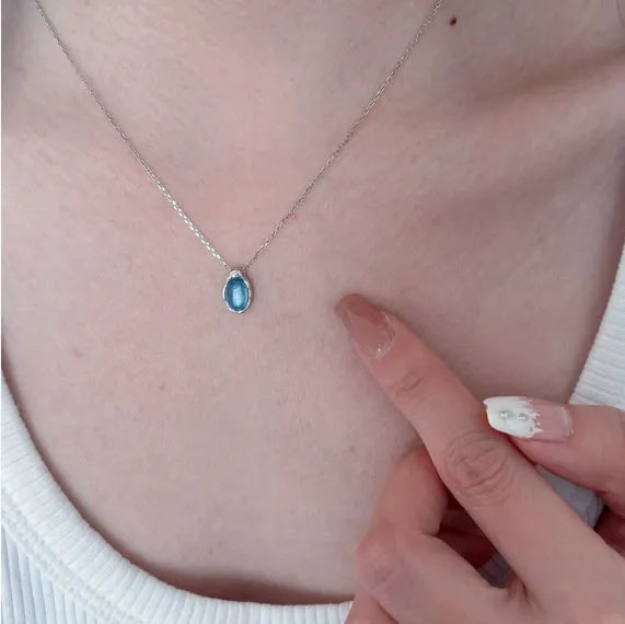 Navy blue water drop pendant necklace with geometric copper design on cross chain