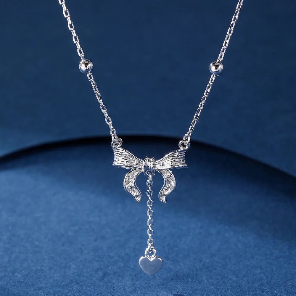 Women's 925 silver butterfly heart and bow pendant necklace on an adjustable O-ring chain.