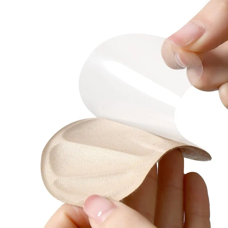 Three pairs of camel-coloured suede heel cushion pads for women's shoes on a white background.