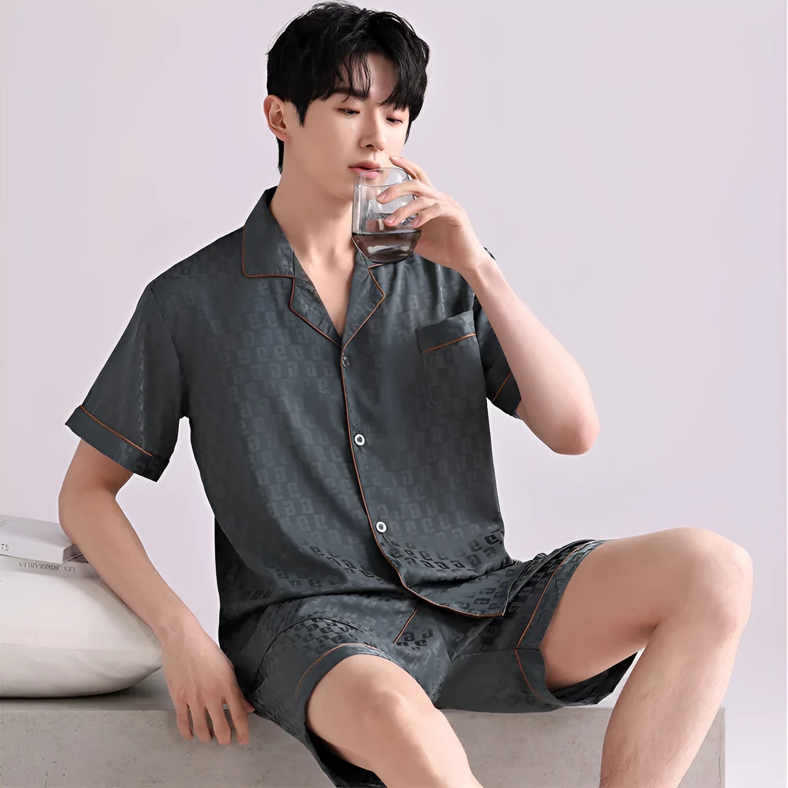 Men's ice silk pyjama set in a black satin jacquard plaid pattern, showing cardigan top and matching shorts.