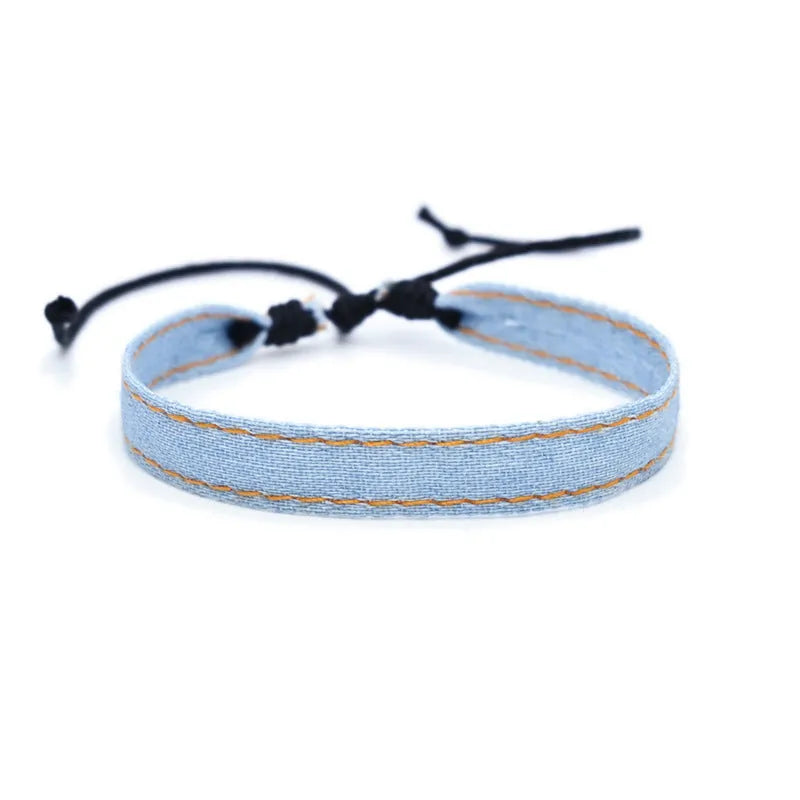 Handmade denim fabric wristband carrying strap in mixed materials with adjustable closure