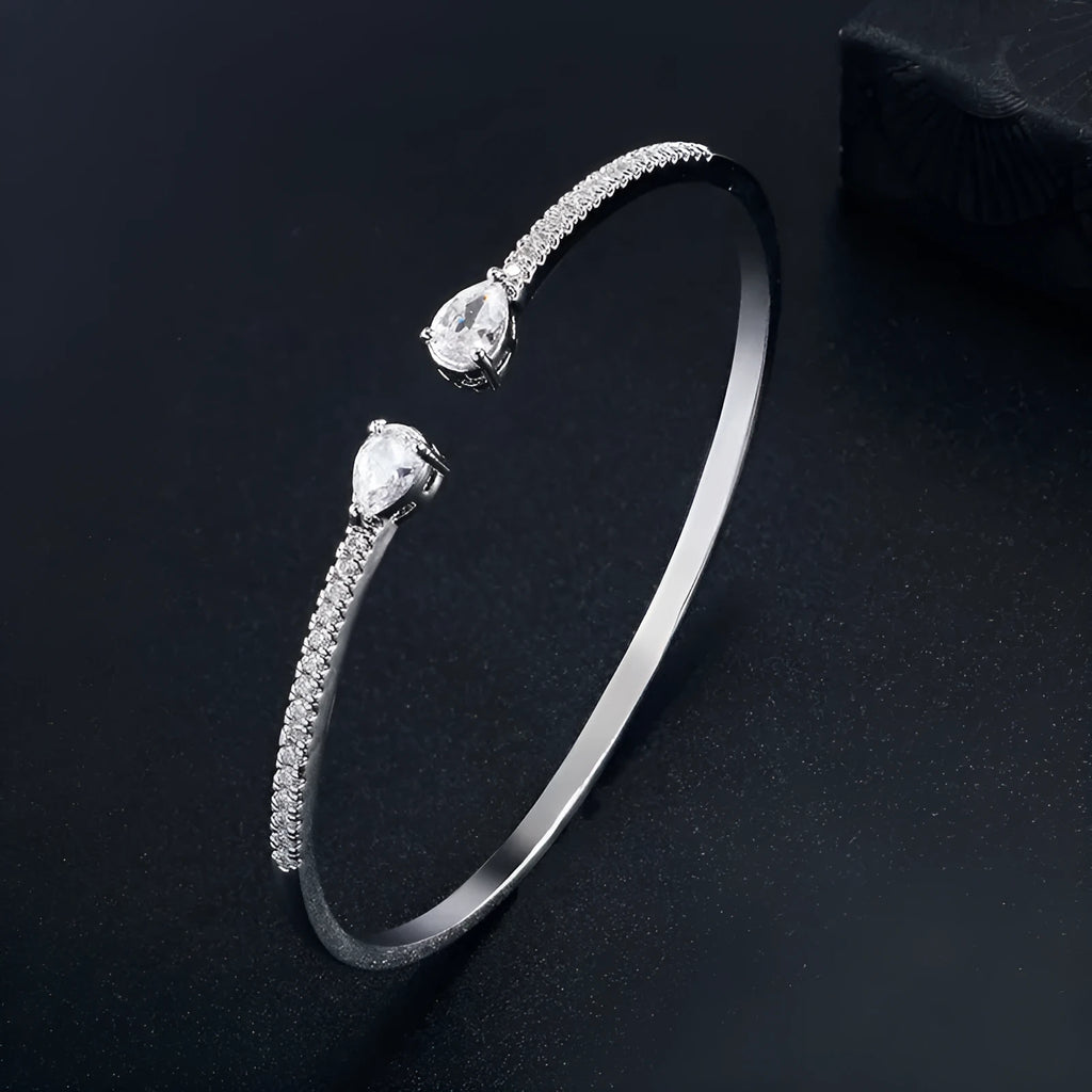 Personalised multi-zircon bracelet in copper, showing detailed inlaid stonework in a simple band style.