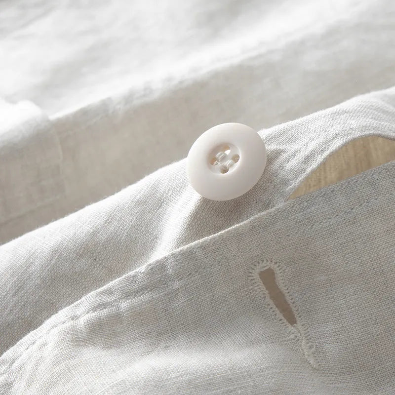 Men's loose fit linen suit jacket in a solid colour on a hanger, showing casual long sleeve design.